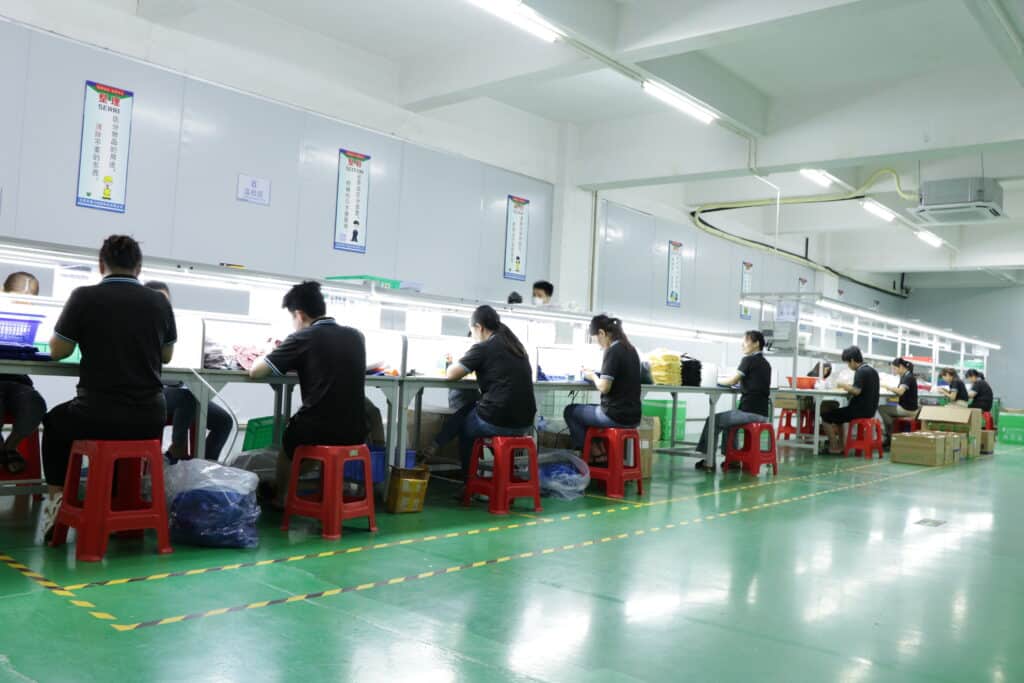 Technician performing final inspection on silicone products before shipment for quality control"