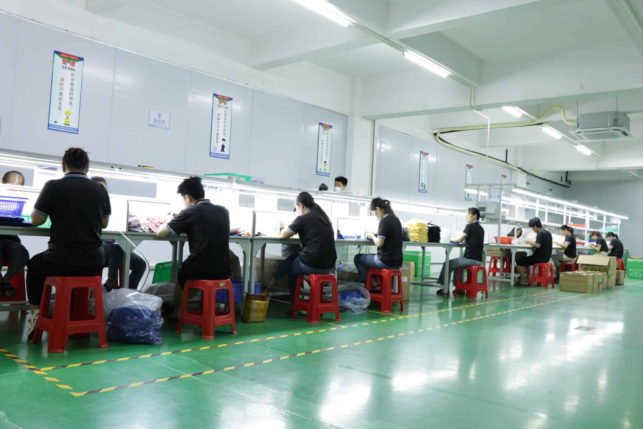 Technician performing final inspection on silicone products before shipment for quality control"