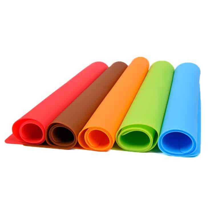 Colorful flexible silicone mats showing different material colors and thickness options for custom applications