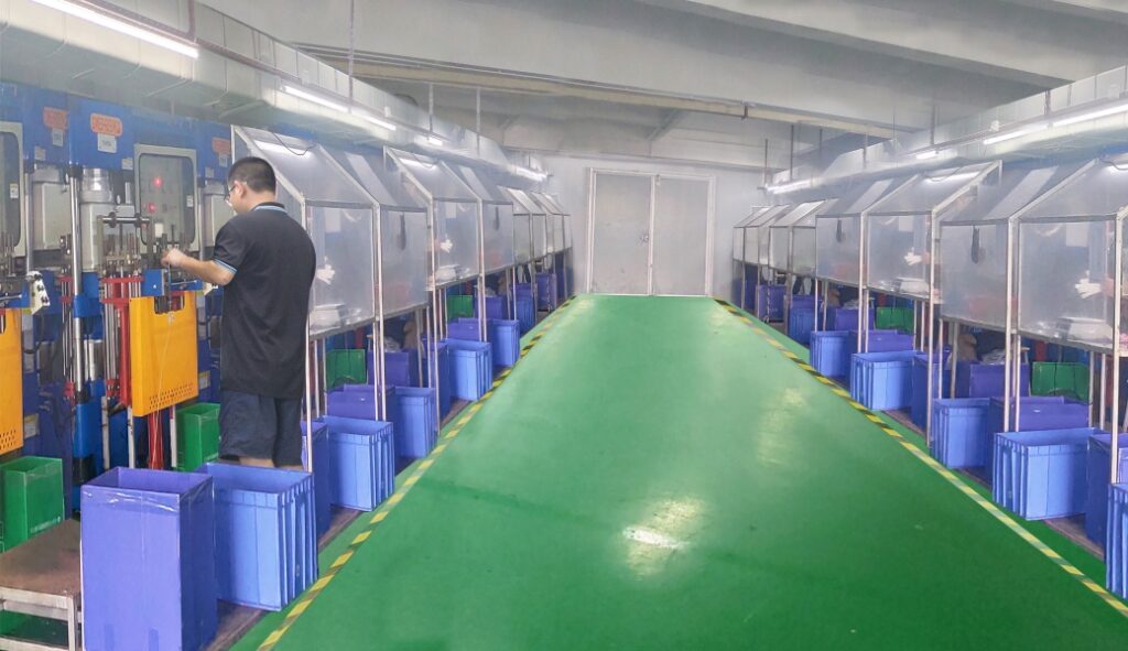 Professional silicone compression molding workshop featuring a row of hydraulic press machines and workers performing quality checks.