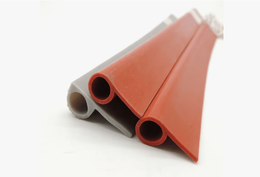 Close-up of red and gray silicone sealing strips for automotive and industrial applications, highlighting precision extrusion and material flexibility