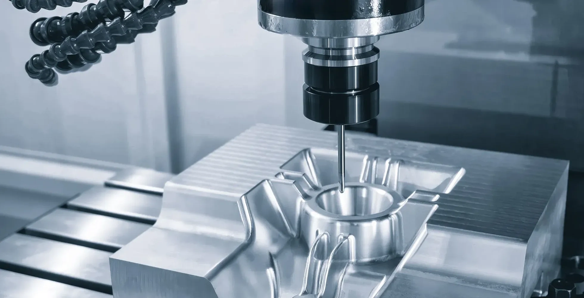 CNC machine precisely machining a steel mold block for custom silicone tooling