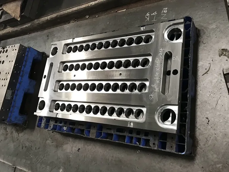 Multi cavity steel mold block with multiple identical cavities arranged in rows for silicone molding production
