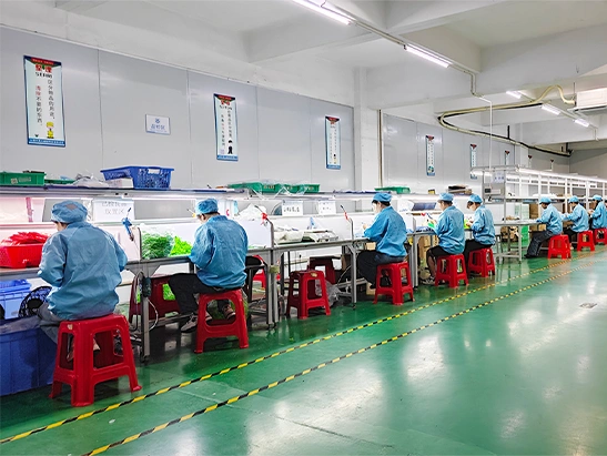 Workers assembling and packaging custom silicone products in a clean production environment