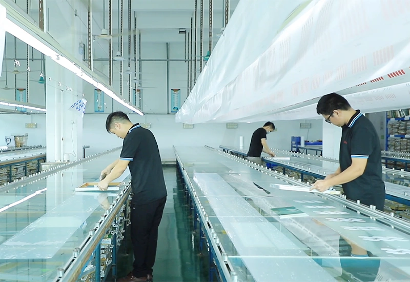 Workers performing silk screen printing on custom silicone products in the production line