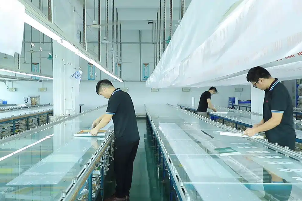 Workers in cleanroom assembling custom silicone products at HT Silicone factory assembly line in Dongguan