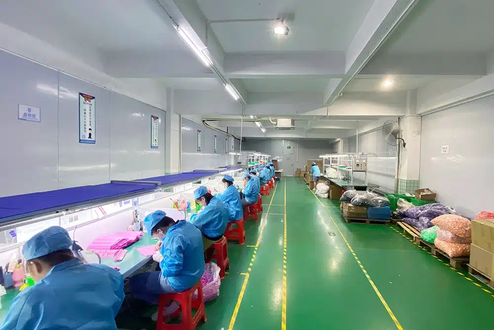 Quality control inspectors examining silicone products in cleanroom inspection workshop at HT Silicone factory