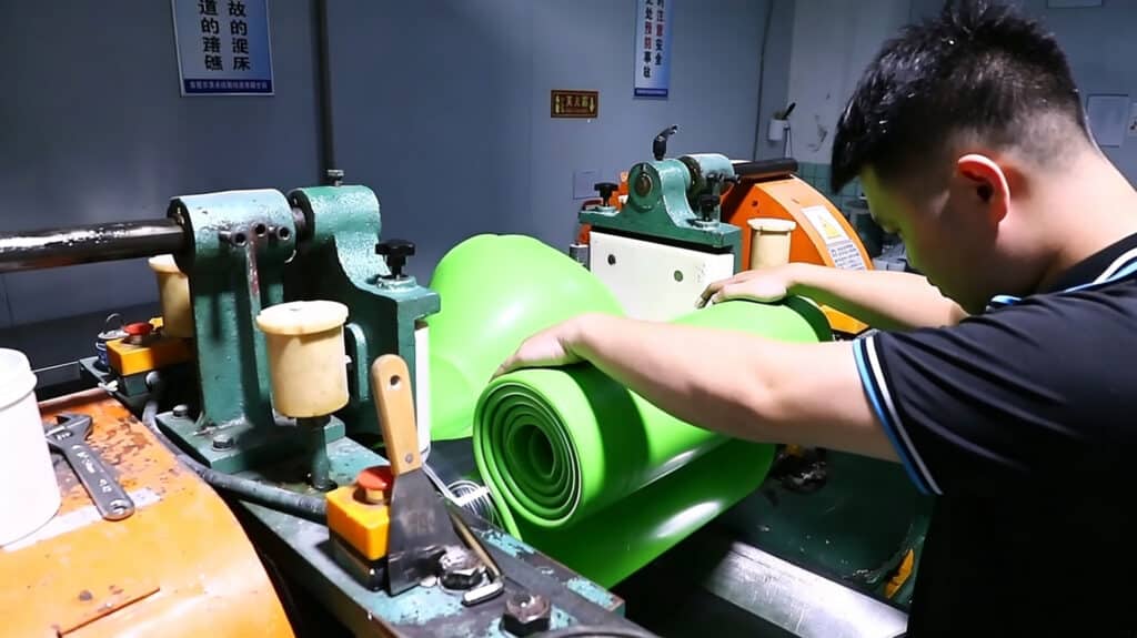 Green silicone material being processed for custom silicone products, showing how Pantone color matching depends on pigment formulation, silicone material, thickness, curing conditions, and physical sample approval.