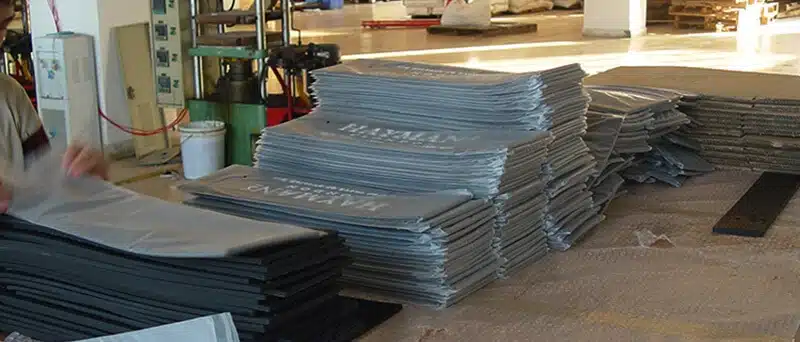 Bulk production of custom silicone mats stacked in a factory workshop
