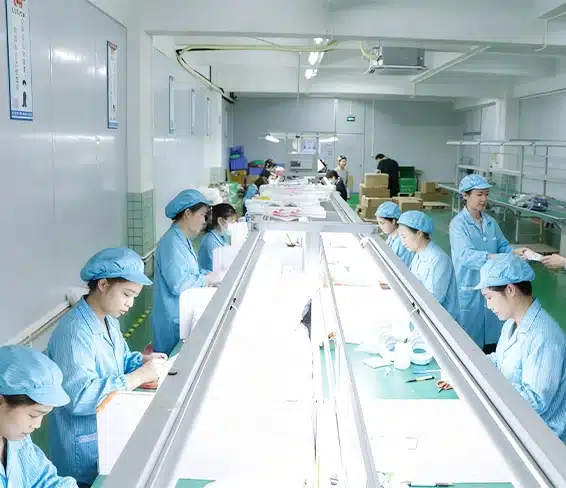 Custom silicone product assembly line with workers performing manual inspection and packaging